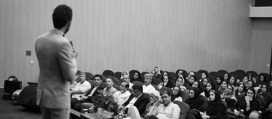 A speaker giving a talk to a full auditorium